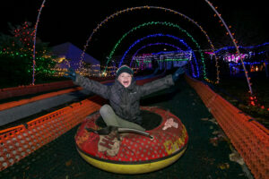 Kid having fun while snowless tubing